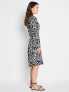 Indigo Leaf dress, navy with white abstract leaf pattern. Long sleeves, knee-length.