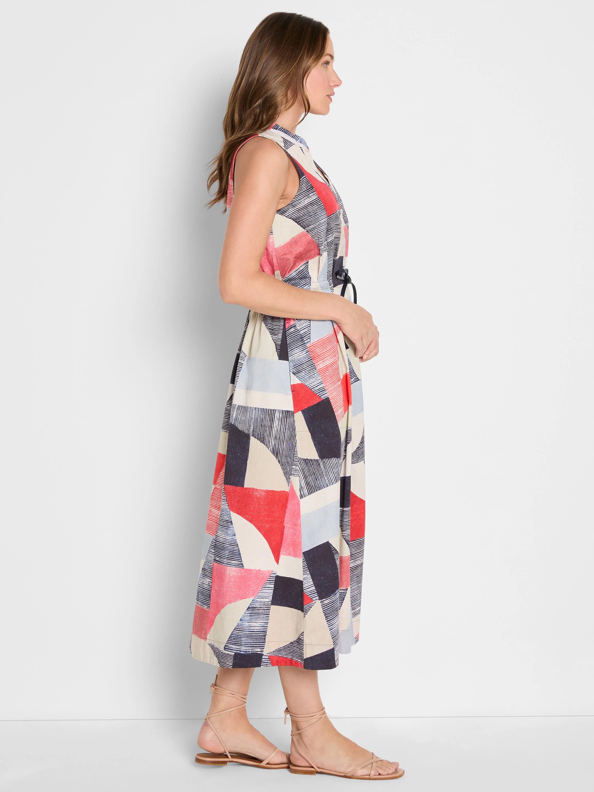 Sleeveless midi dress with geometric pattern in red, navy, light blue, and beige. Features a tie-waist.