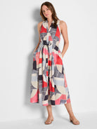 Sleeveless V-neck midi dress in red, navy, light blue, and cream geometric print with a tied waist. Pockets.