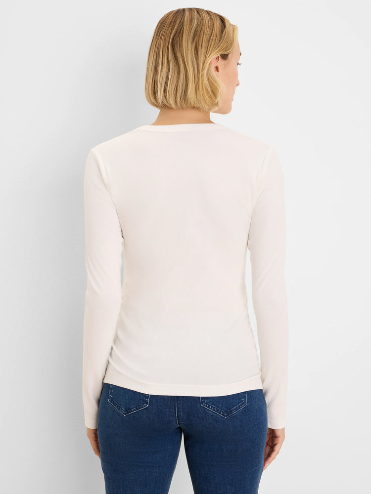 Off-white, fitted rib knit long-sleeve tee, back view on model. Features a round neckline.