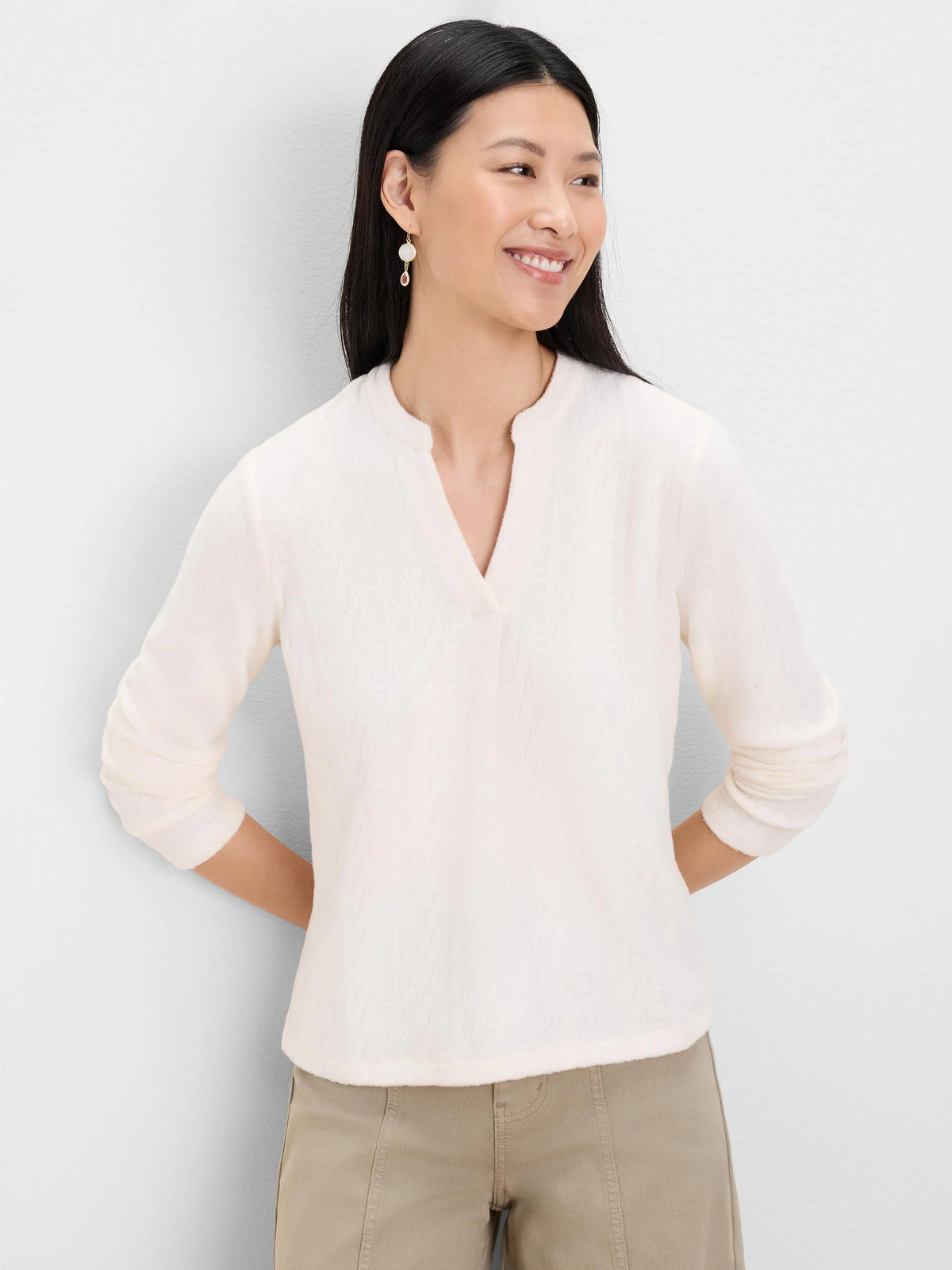 Light cream top with subtle cable knit texture, split V-neck, and 3/4 sleeves.