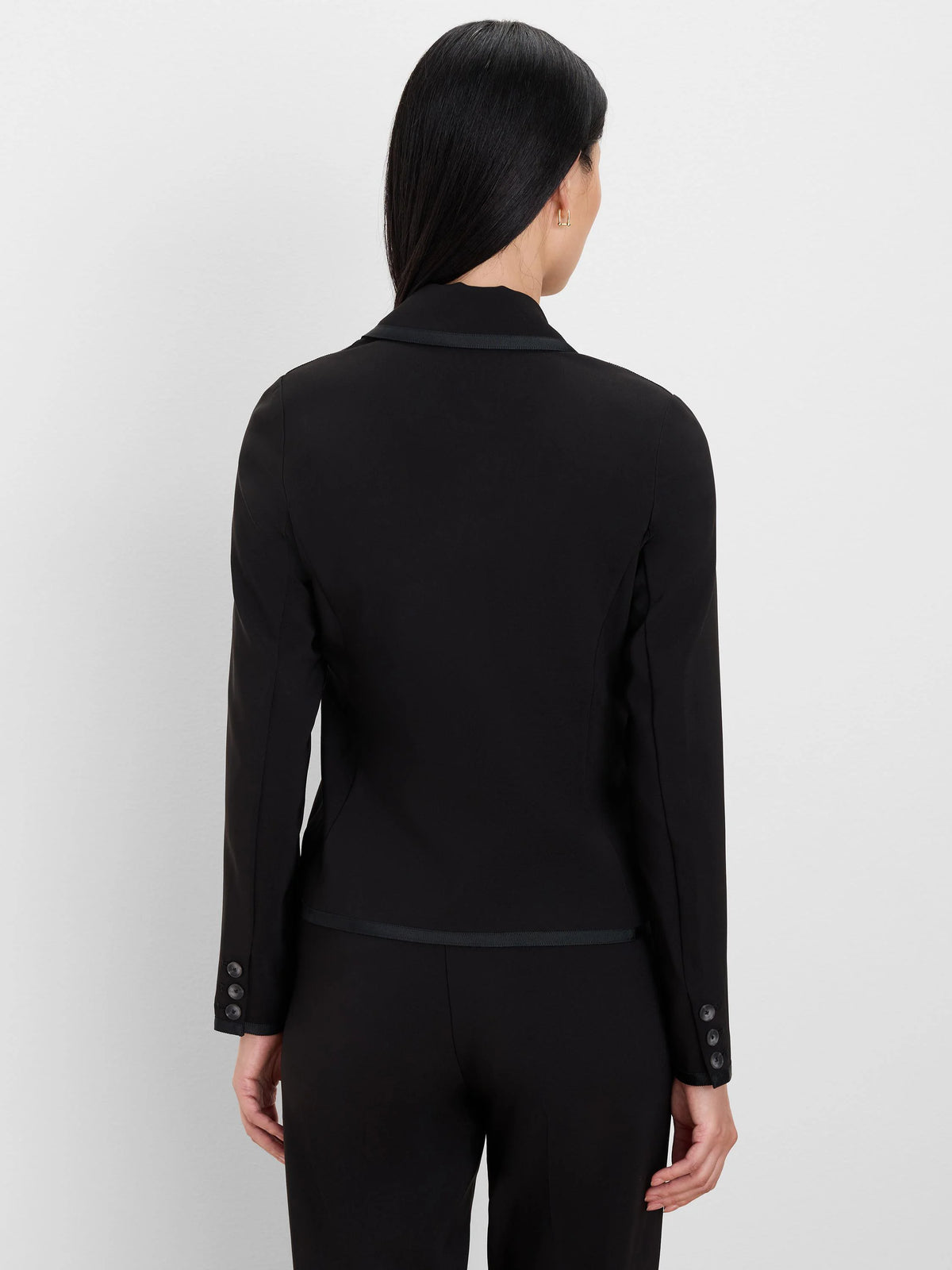 Black blazer, back view, with grosgrain trim on collar and hem, and three buttons on each cuff.
