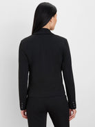 Black blazer with thin light pinstripes, three dark buttons on each sleeve cuff. Model's back to camera.