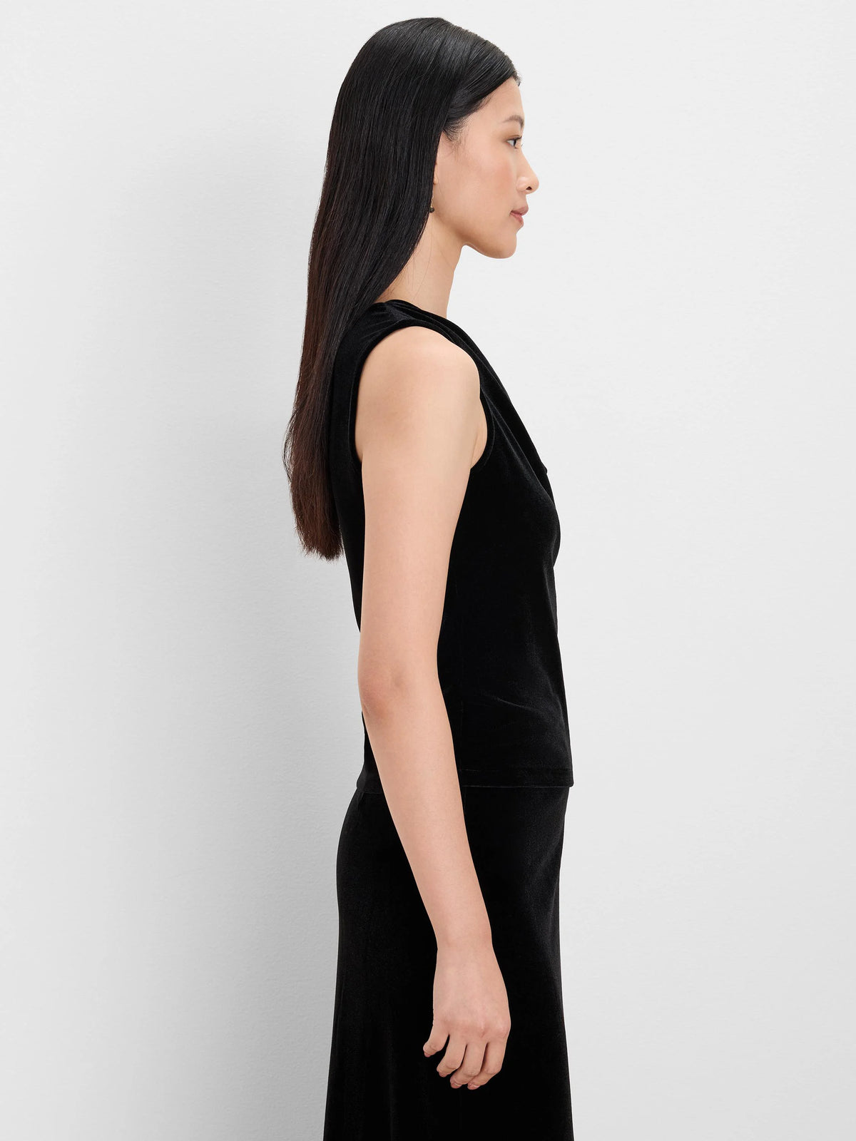 Black velvet drape neck tank, side view on model.