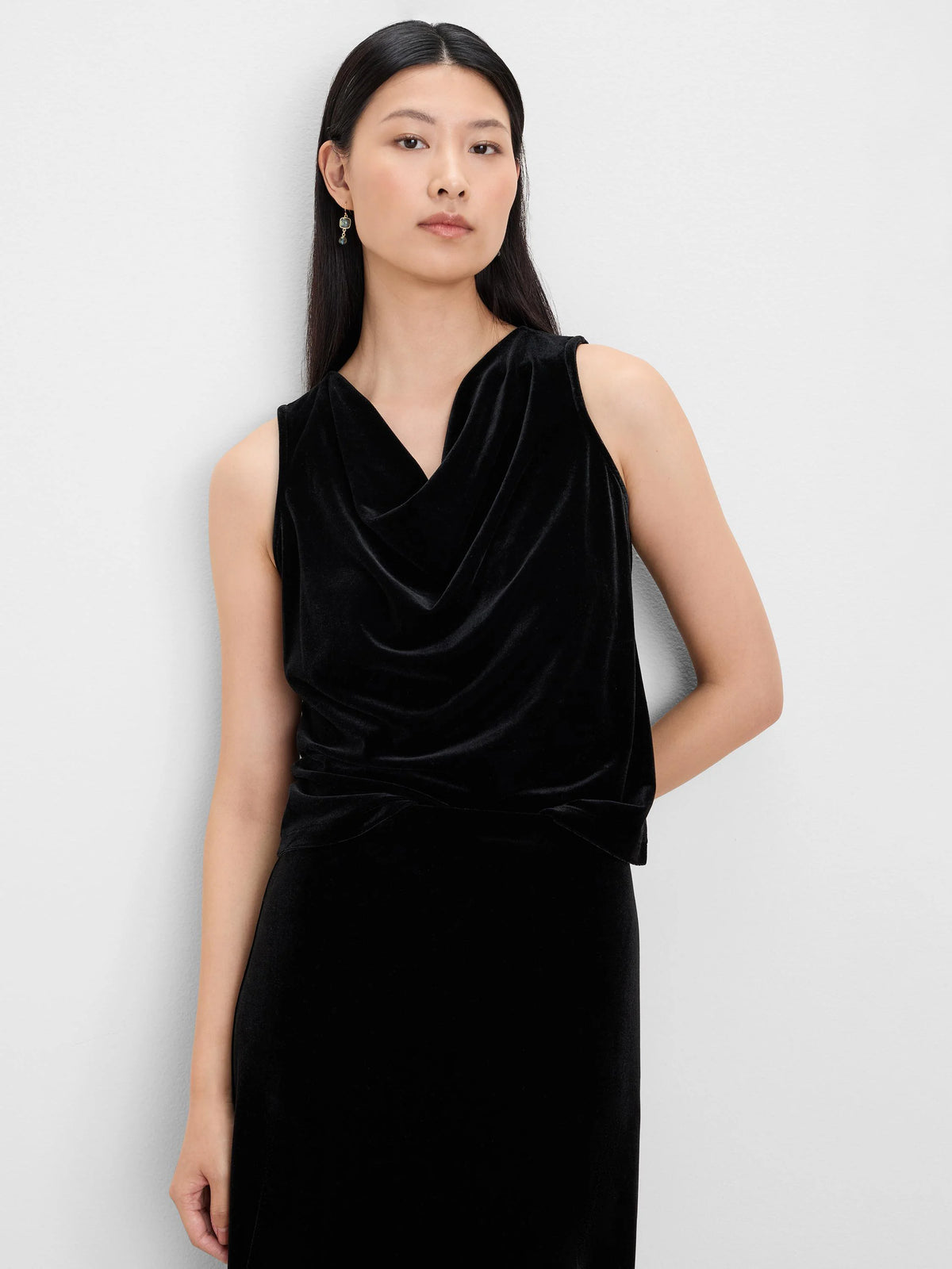 Black velvet sleeveless tank with a draped neck, worn by a model.