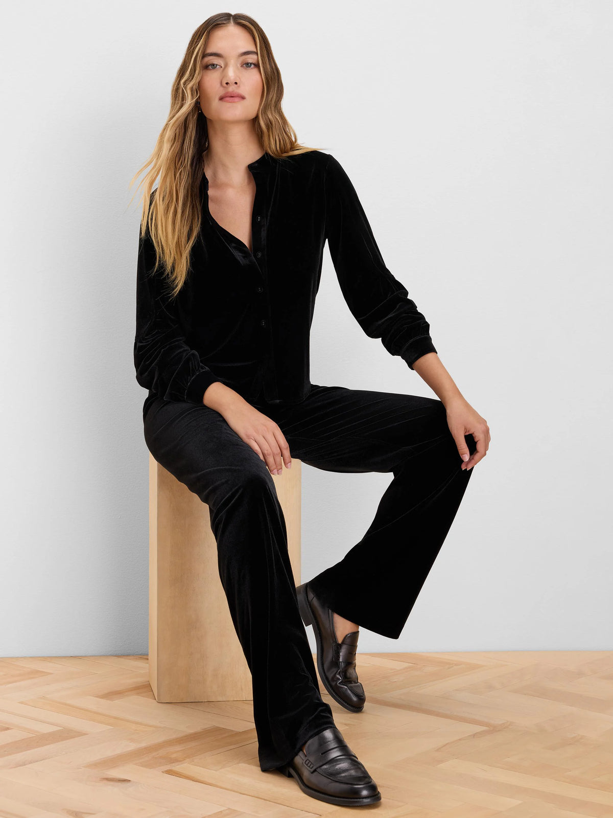 Black velvet button-up top with a band collar and long sleeves featuring gathered cuffs.