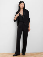 Black knit cami with a V-neck and delicate black lace trim, shown under a blazer.