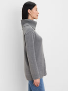 Grey foldover turtleneck sweater with ribbed turtleneck, cuffs, and hem.