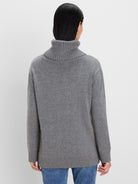 Grey knit sweater, back view. Features a folded, ribbed turtleneck, ribbed cuffs & hem.