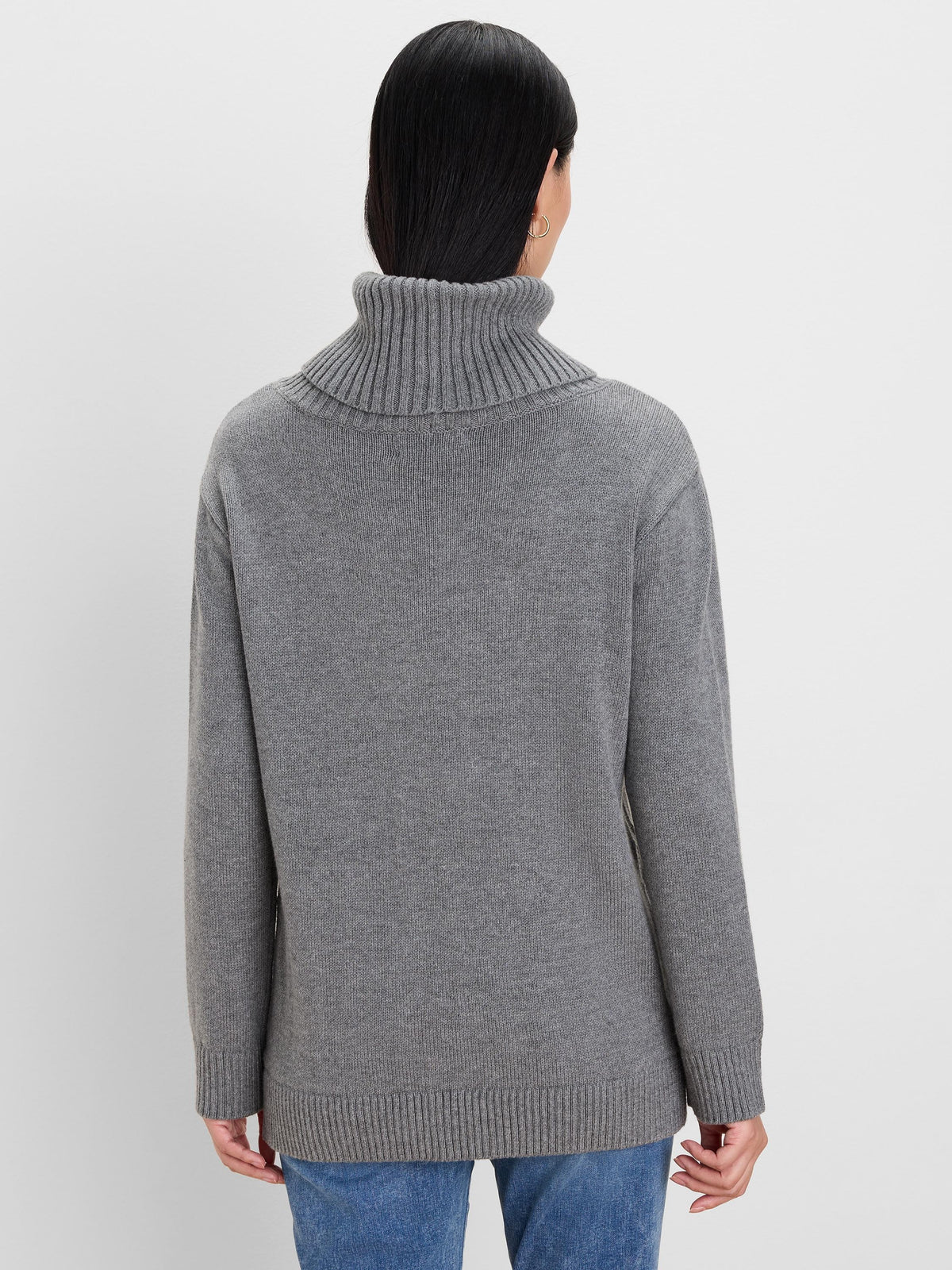 Grey knit sweater, back view. Features a folded, ribbed turtleneck, ribbed cuffs & hem.