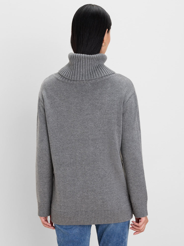 Grey knit sweater, back view. Features a folded, ribbed turtleneck, ribbed cuffs & hem.