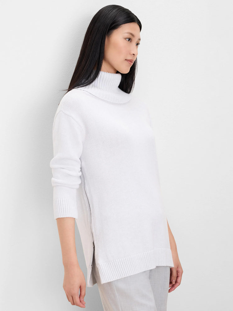 White foldover turtleneck sweater with long sleeves, ribbed cuffs/hem, and a partially unzipped side vent.
