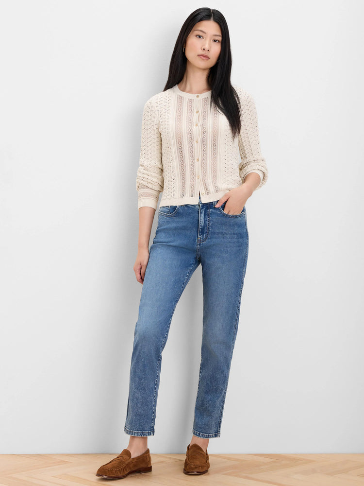 Cream filigree knit cardigan with an openwork pattern, light buttons down the front.