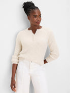 Cream fuzzy sweater with a subtle parquet knit pattern and 3-button henley V-neck.