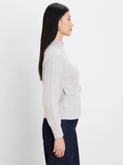 Light grey loopy knit jacket with mock neck, half-zip, and ribbed patch pocket.
