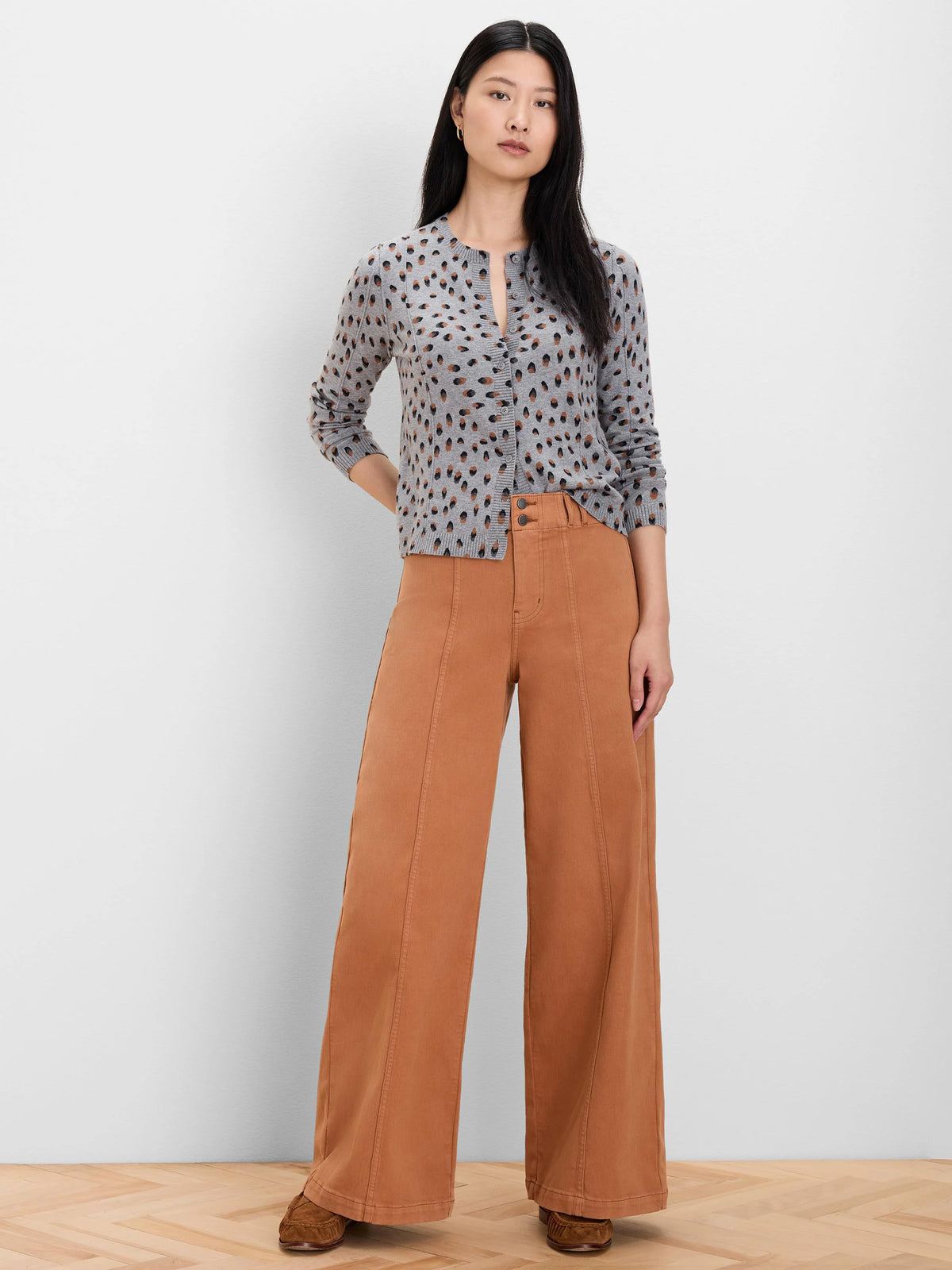 Grey button-front cardigan with irregular brown and black dot pattern. Long sleeves.