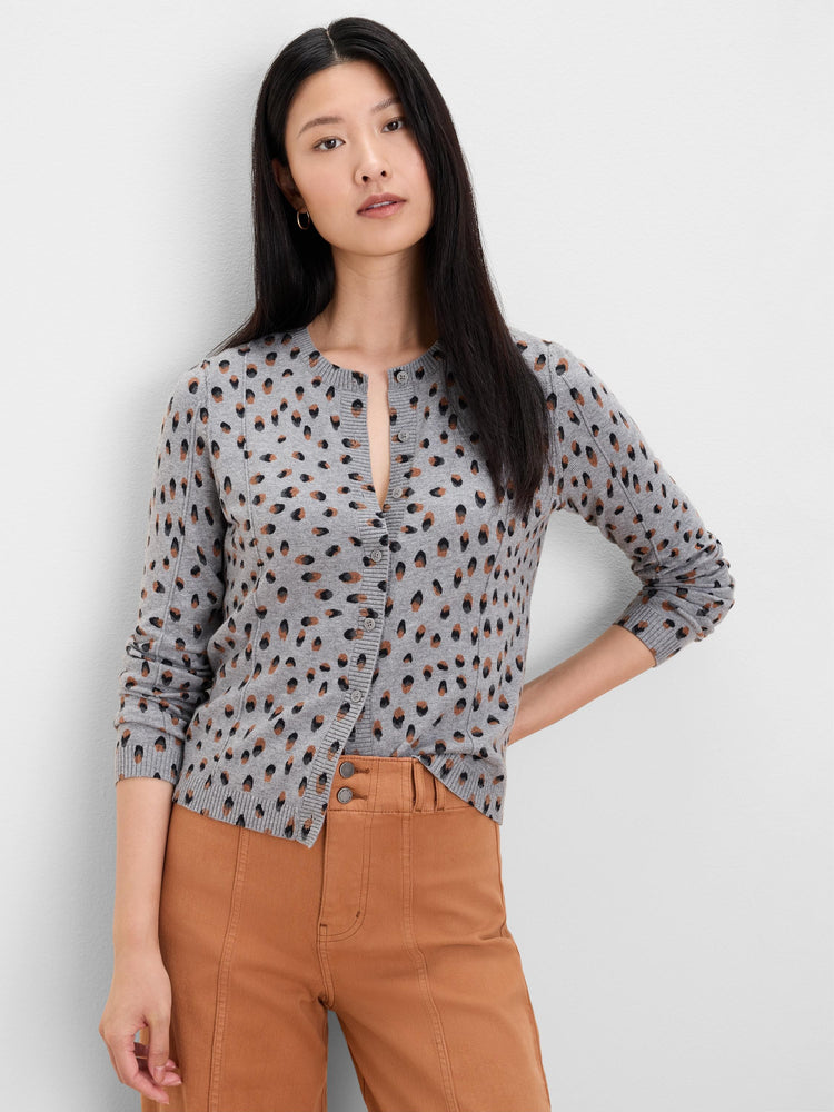 Grey button-front cardigan with irregular black and brown dots, crew neck, long sleeves.