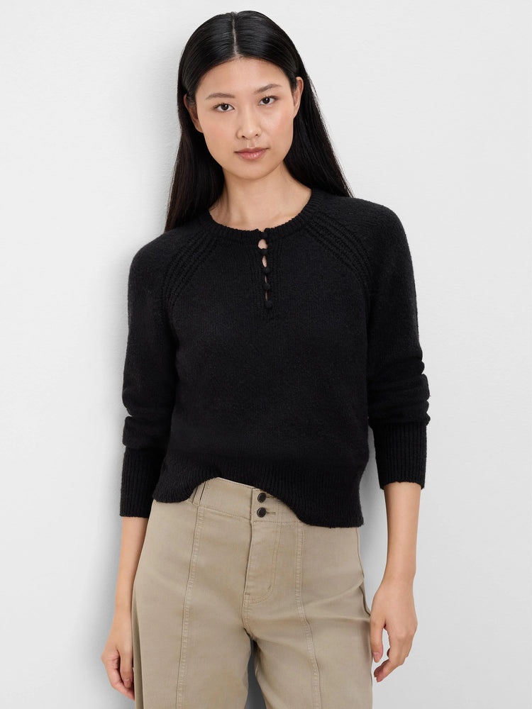Black, fuzzy sweater with a 3-button henley placket, raglan sleeves, ribbed cuffs, and a slightly cropped hem.
