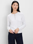 Pale grey knit sweater features a round neck, 4-button henley placket, textured raglan sleeves, and ribbed cuffs/hem.