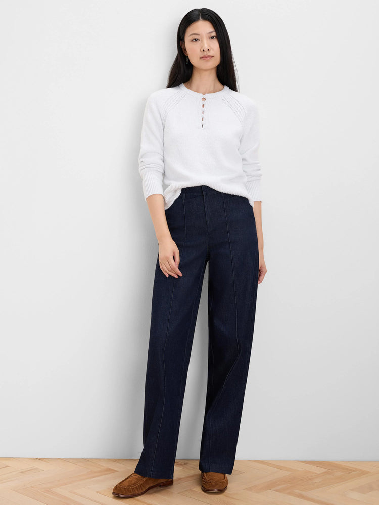 Off-white knit sweater with a round neck, 3-button henley placket, and subtle raglan sleeves.