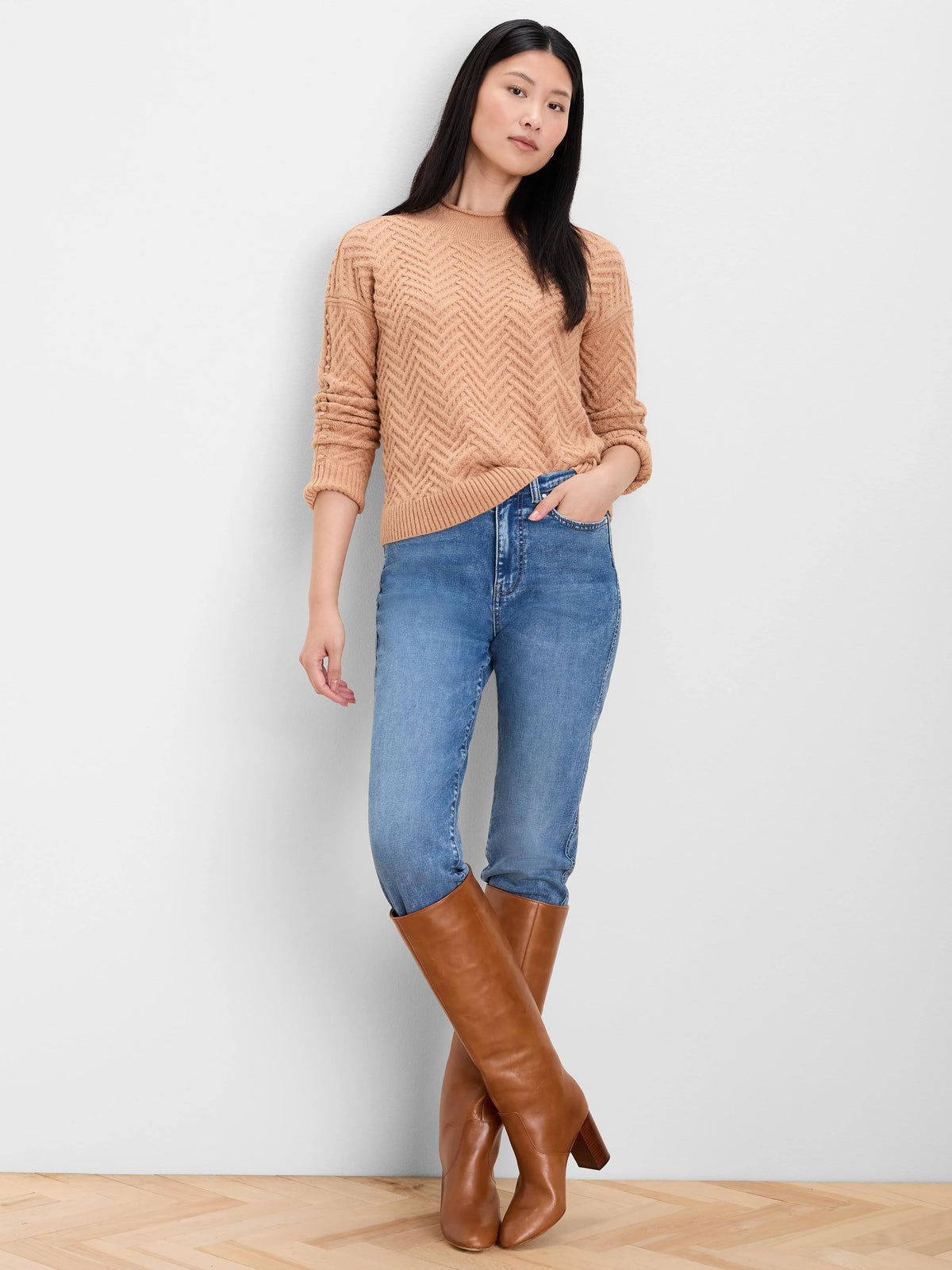 Tan roll neck sweater with a distinct zigzag weave pattern.