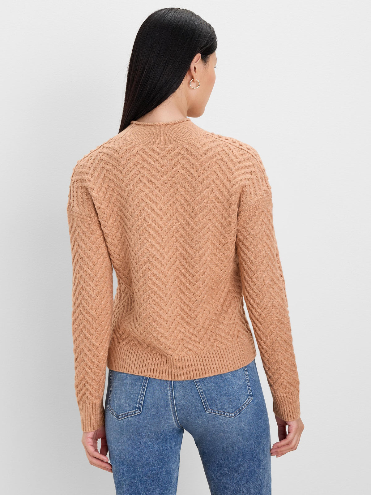 Tan roll neck sweater with a chevron knit pattern on body and sleeves. Ribbed roll neck, cuffs, and hem.