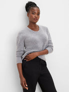 Heather grey slouchy scoop neck sweater, soft fuzzy knit texture, worn by a woman.