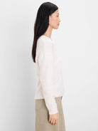 Off-white slouchy scoop neck sweater with a soft, fuzzy knit texture and relaxed fit.