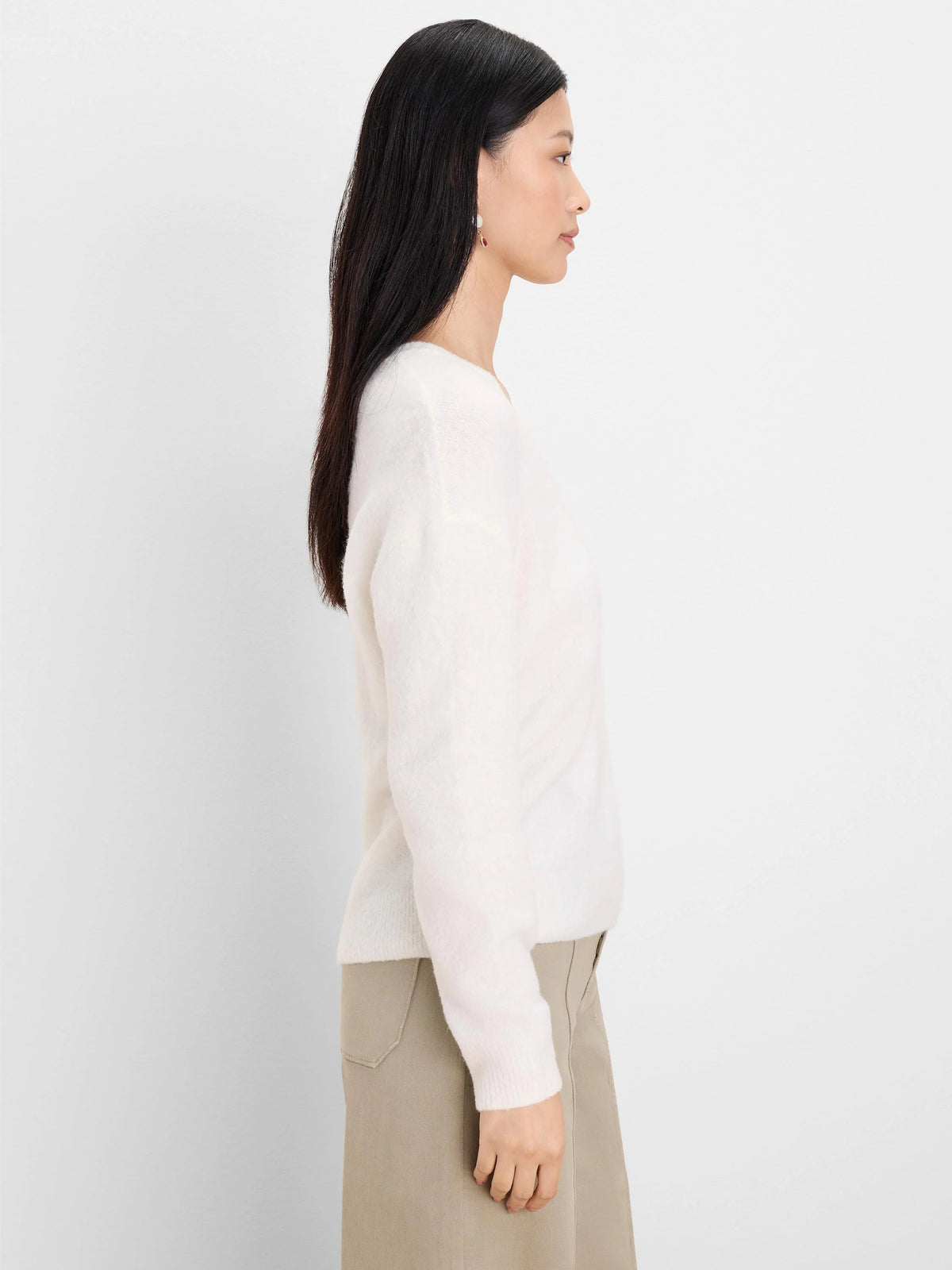 Off-white slouchy scoop neck sweater with a soft, fuzzy knit texture and relaxed fit.