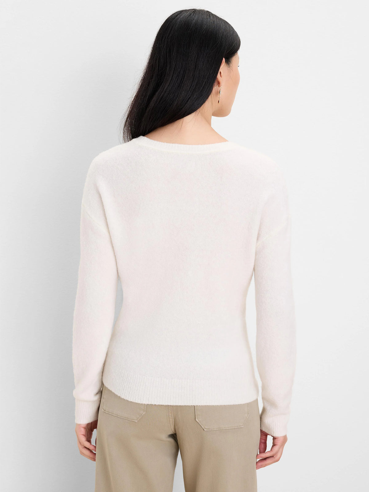 Back view of a cream slouchy scoop sweater with a soft, fuzzy knit texture, ribbed cuffs, and hem.