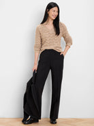 Fuzzy tan V-neck sweater with a raised scallop knit pattern.