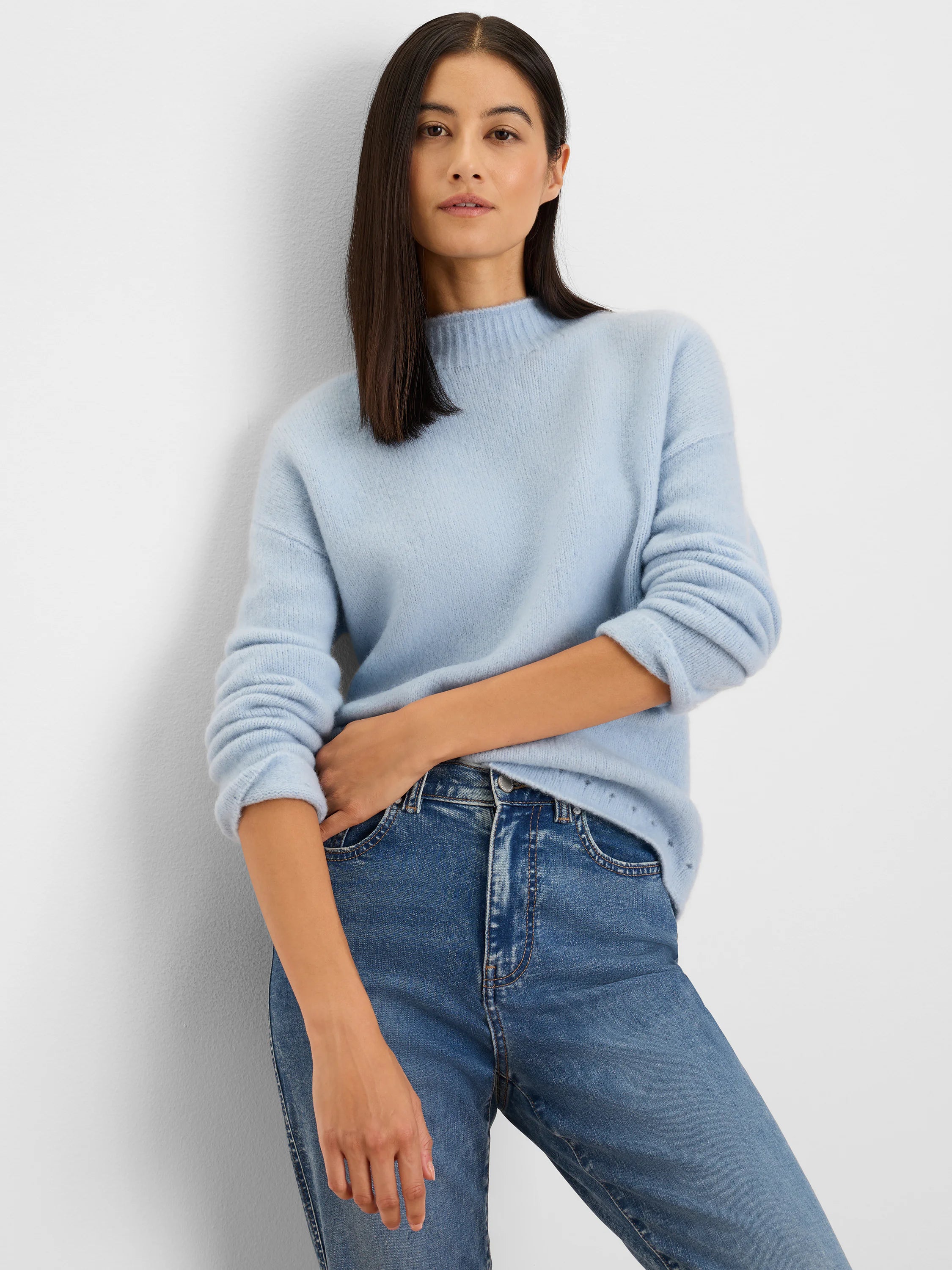 Light blue fuzzy knit sweater with a mock neck, ribbed cuffs, and hem.