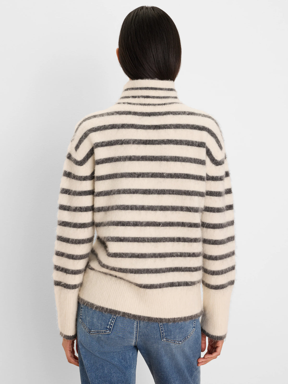 Cream brushed sweater with dark gray horizontal stripes, fuzzy texture, and mock neck.