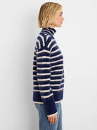 Navy and off-white striped turtleneck sweater with a brushed, fuzzy texture.