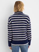 Navy and cream brushed sweater with horizontal stripes and a high neck, seen from the back on a model.