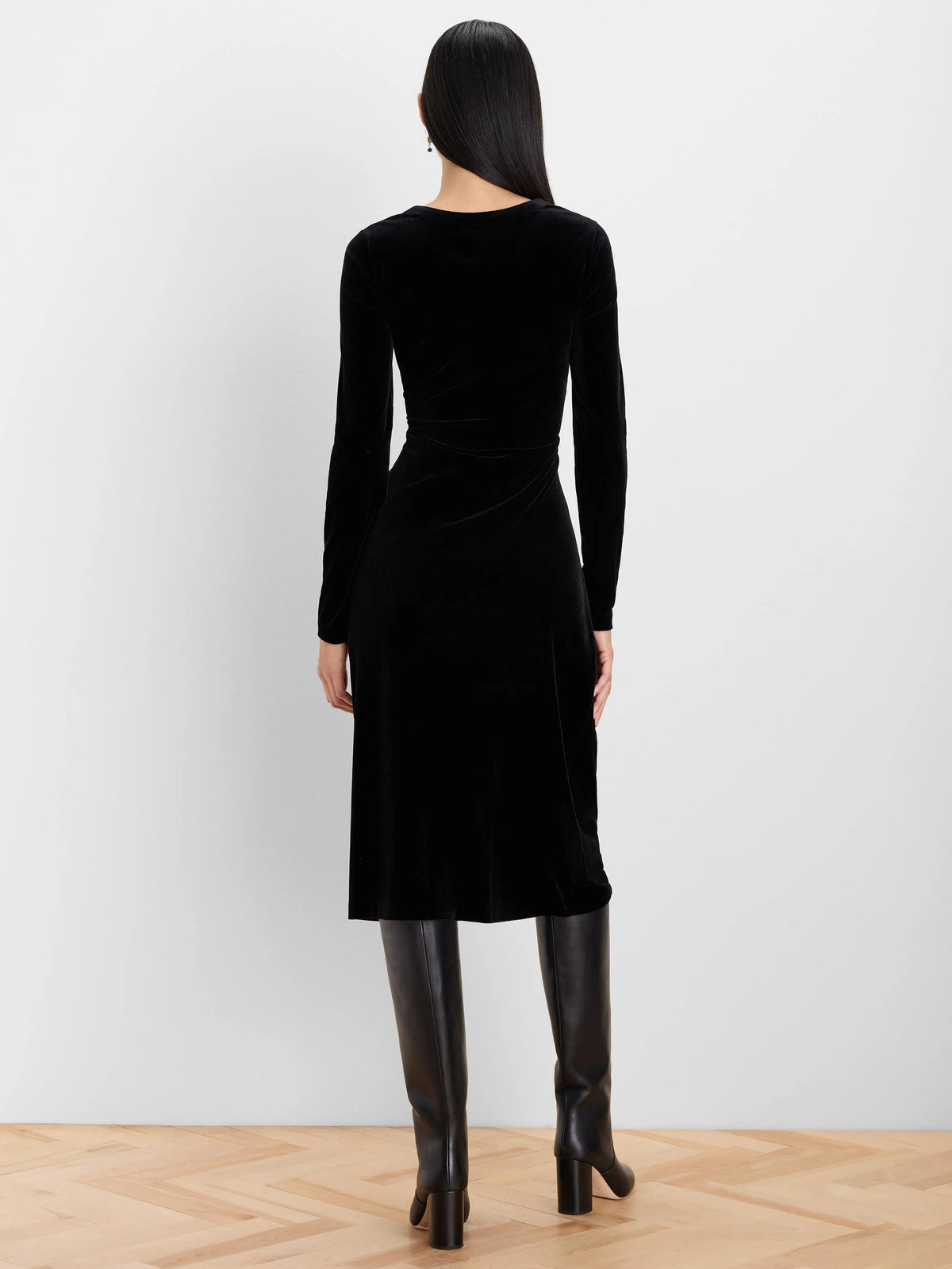 Black velvet long-sleeve midi dress, back view, with a gathered waist detail.