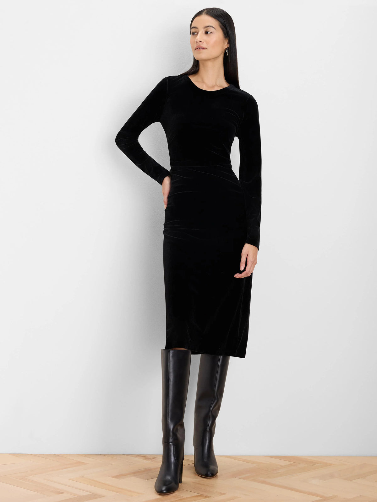 Black velvet long-sleeve midi dress with a round neck and gathered detail at the waist.