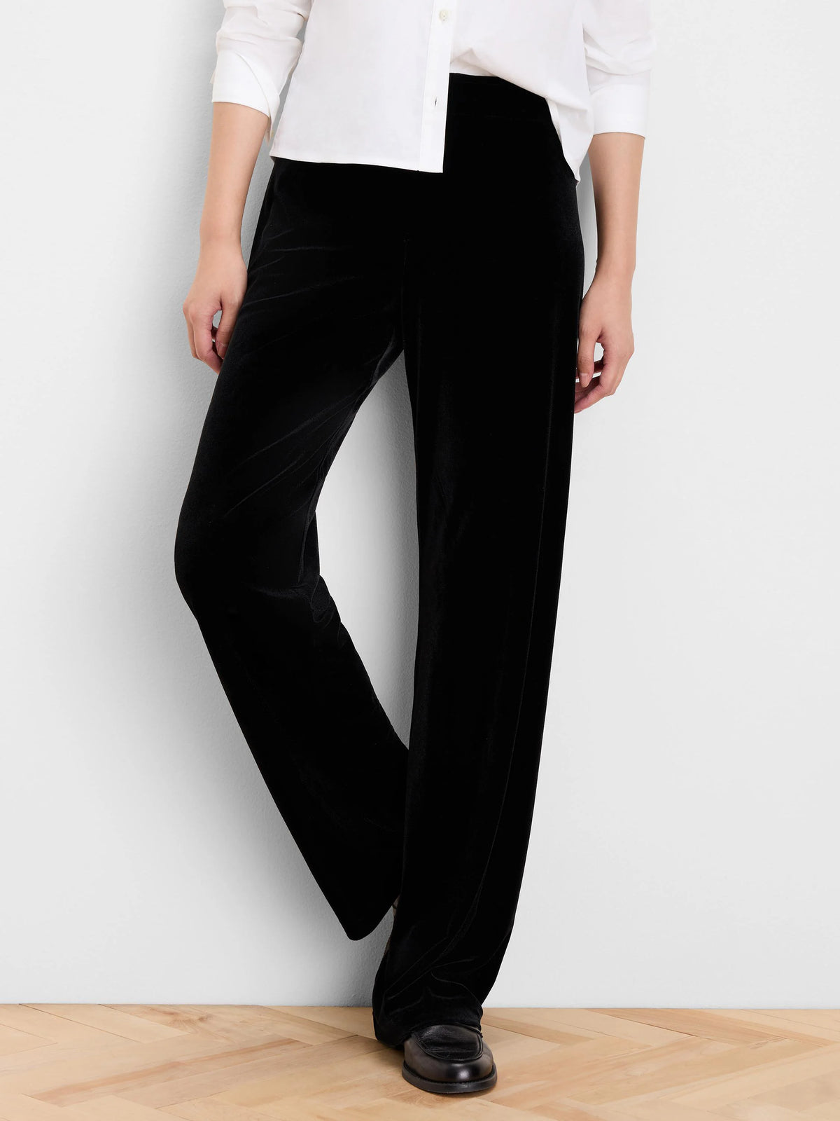 Black velvet wide-leg pants with a soft sheen.