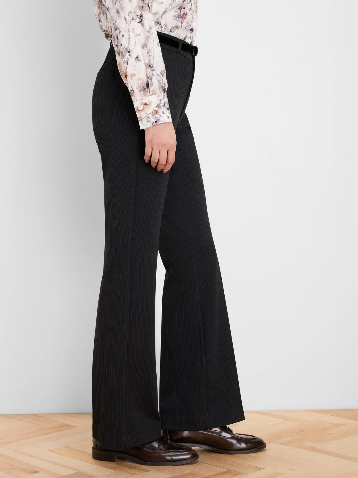 Black bootcut pants with subtle pinstripes.