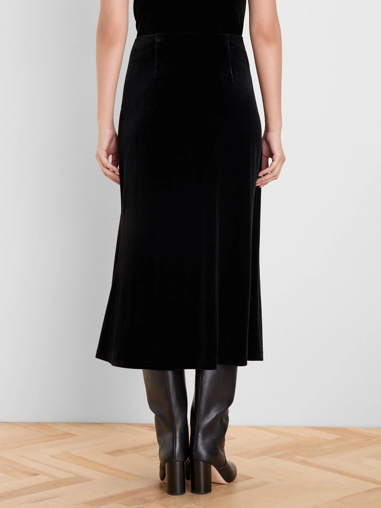 Black velvet midi slip skirt, back view. Smooth, flowing fabric with a subtle sheen.