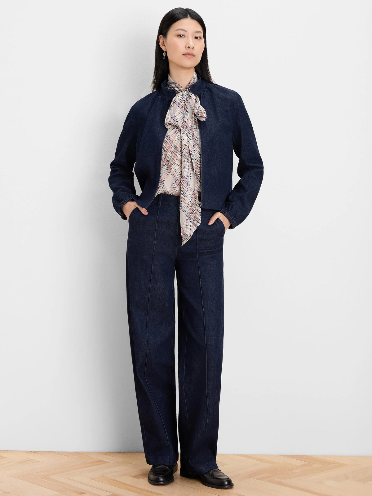 Dark indigo denim jacket with a band collar, zip front, and elastic cuffs.