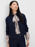 Cropped dark blue denim jacket with full-zip, standing collar, and elasticized cuffs.