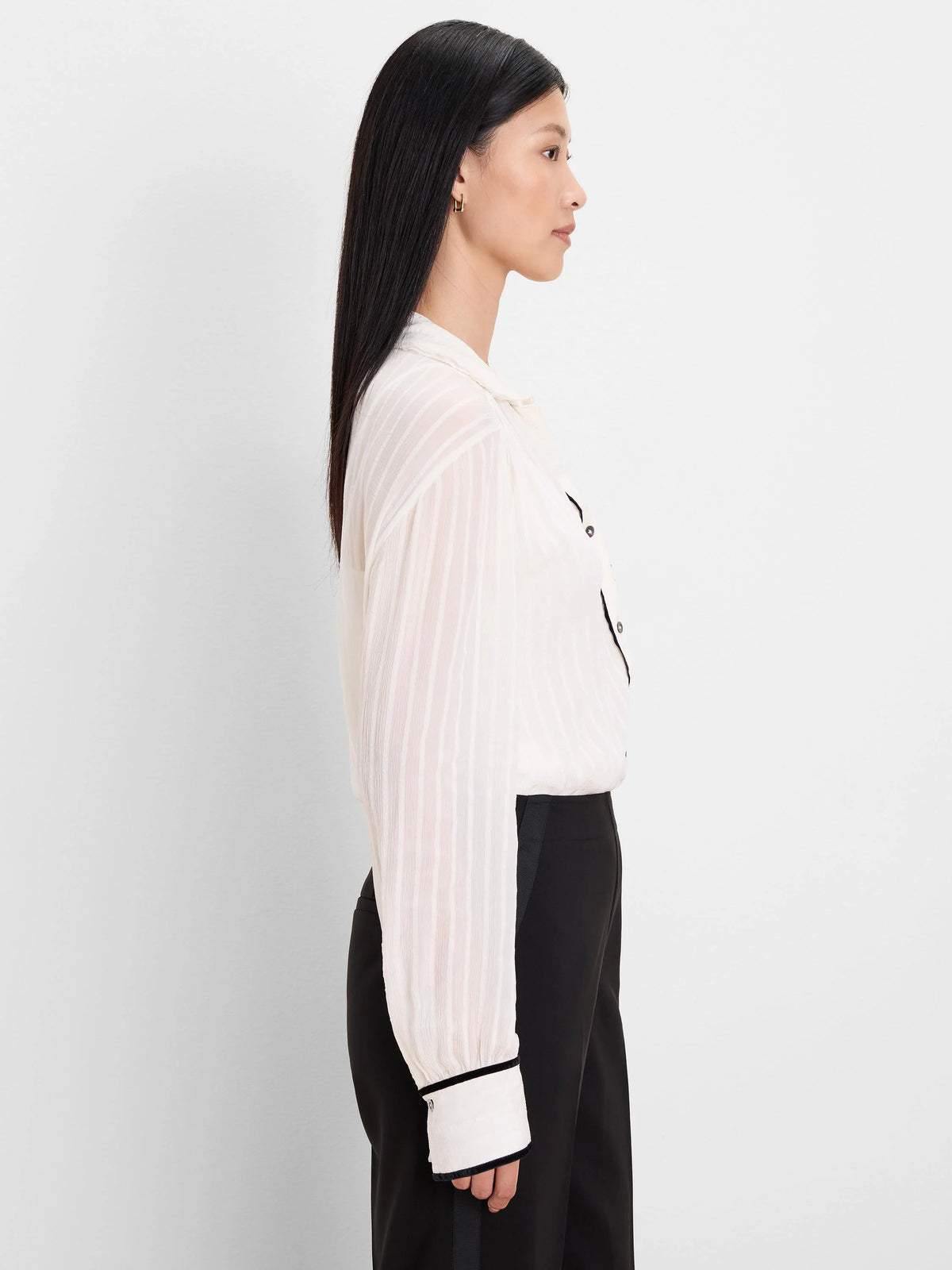Textured cream shirt with black velvet trim on the collar, button placket, and cuffs.
