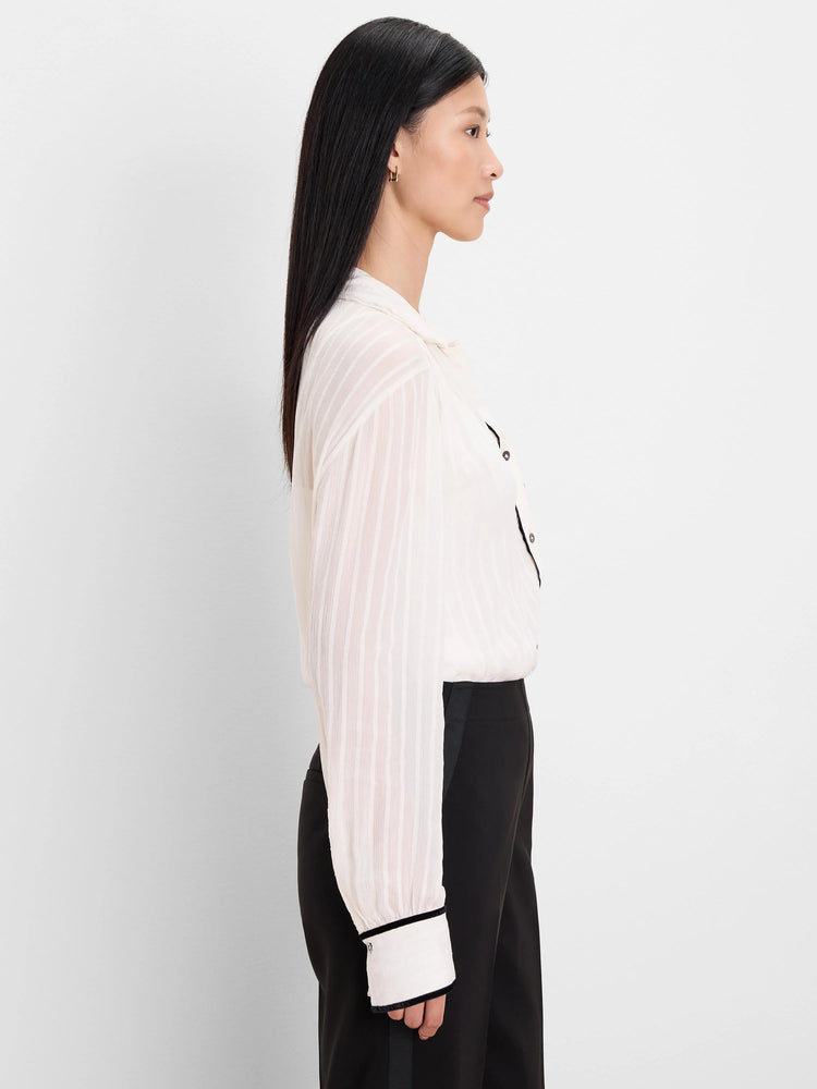 Textured cream shirt with black velvet trim on the collar, button placket, and cuffs.