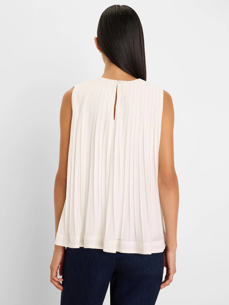 Cream pleated tank, back view. Sleeveless with a keyhole cutout and button closure at the neck.