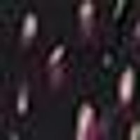 Dark, mottled texture with blurred flecks of muted pink and deep green.