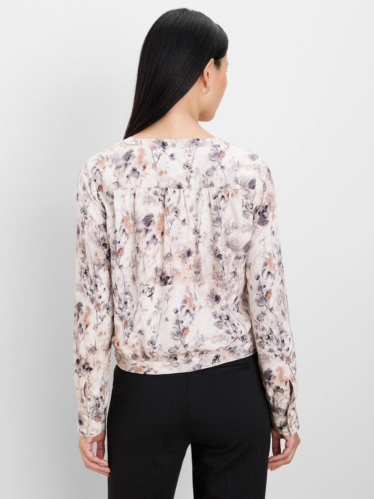 Lumeria Shirt: Cream long-sleeve shirt with muted purple-gray and rust floral print. Features a gathered back and...