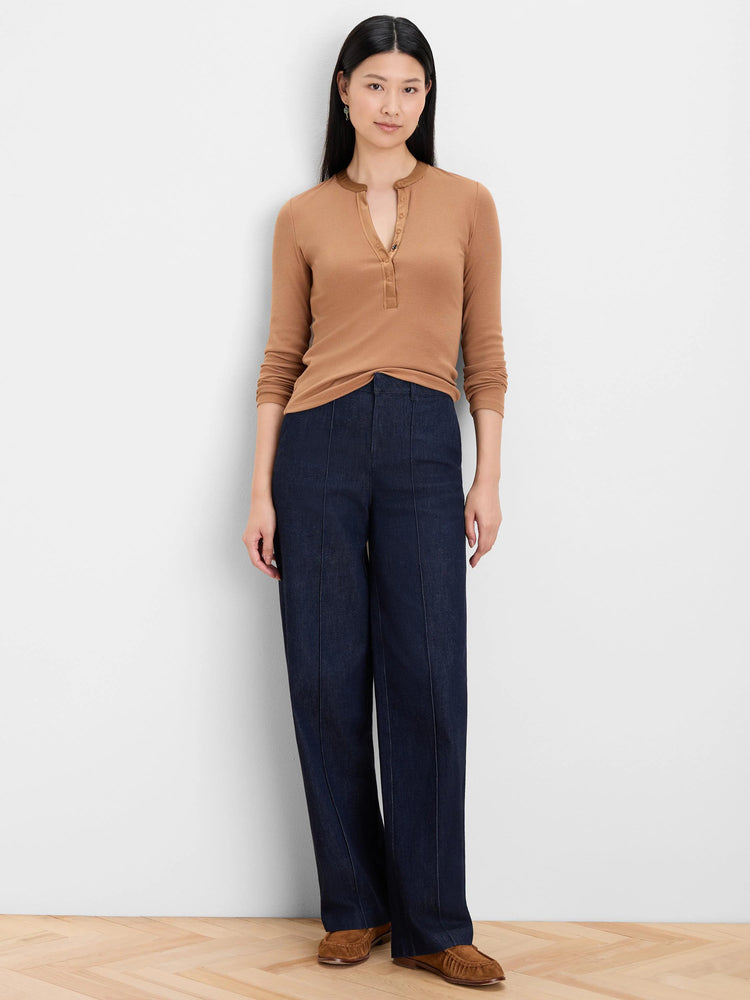Dark indigo wide leg jeans featuring distinct vertical seams down the front of each leg.