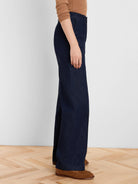 Dark wash, high-waisted, wide leg jeans with a smooth, refined denim texture and subtle front pockets.
