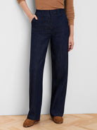 Dark blue wide-leg jeans, high-waisted, with vertical front seams and side pockets.